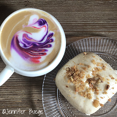 A colorful latte and a doughnut from The Donut + Dog